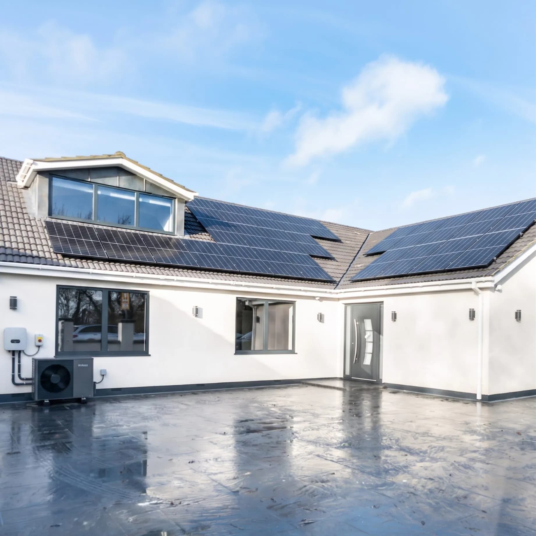 Full solar PV array and air source heat pump installed on a modern Essex home